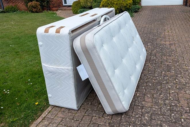 a mattress being taken away for proper disposal